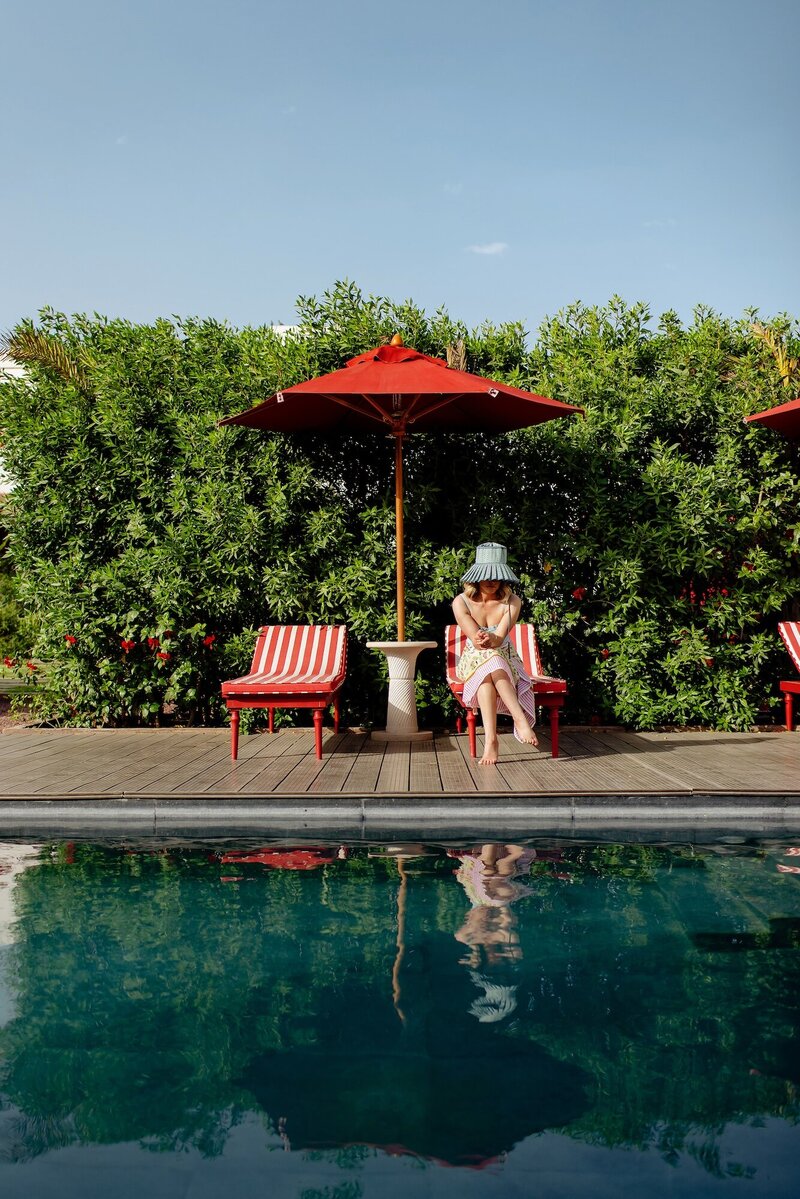 Woman sitting in front of a pool