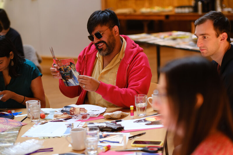 Participant creating a collage during a creative leadership workshop in Seattle, Washington, focused on team building and innovation