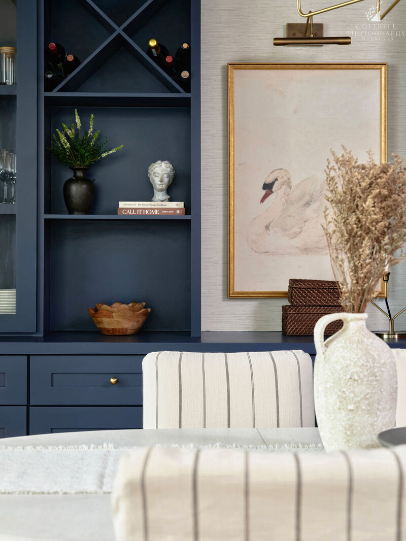 Refined entryway and staircase design in Roswell, Georgia with custom railing, neutral tones, and a warm, welcoming atmosphere by Megan Paterson Interiors.