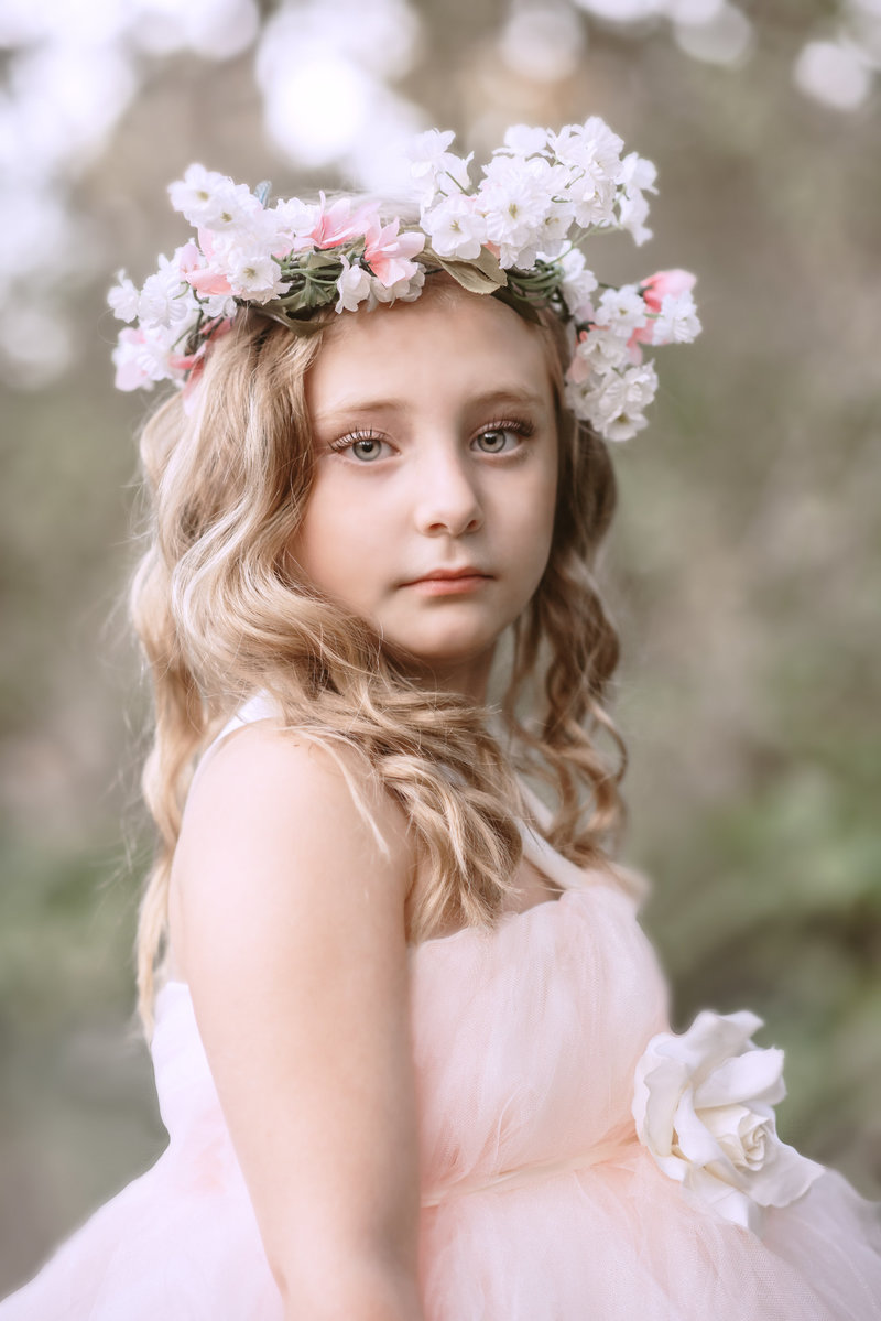 Picture of little girl with floral wreath.