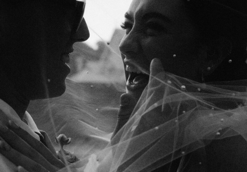 Maleny Manor Wedding. Bride and Groom  under a veil laughing