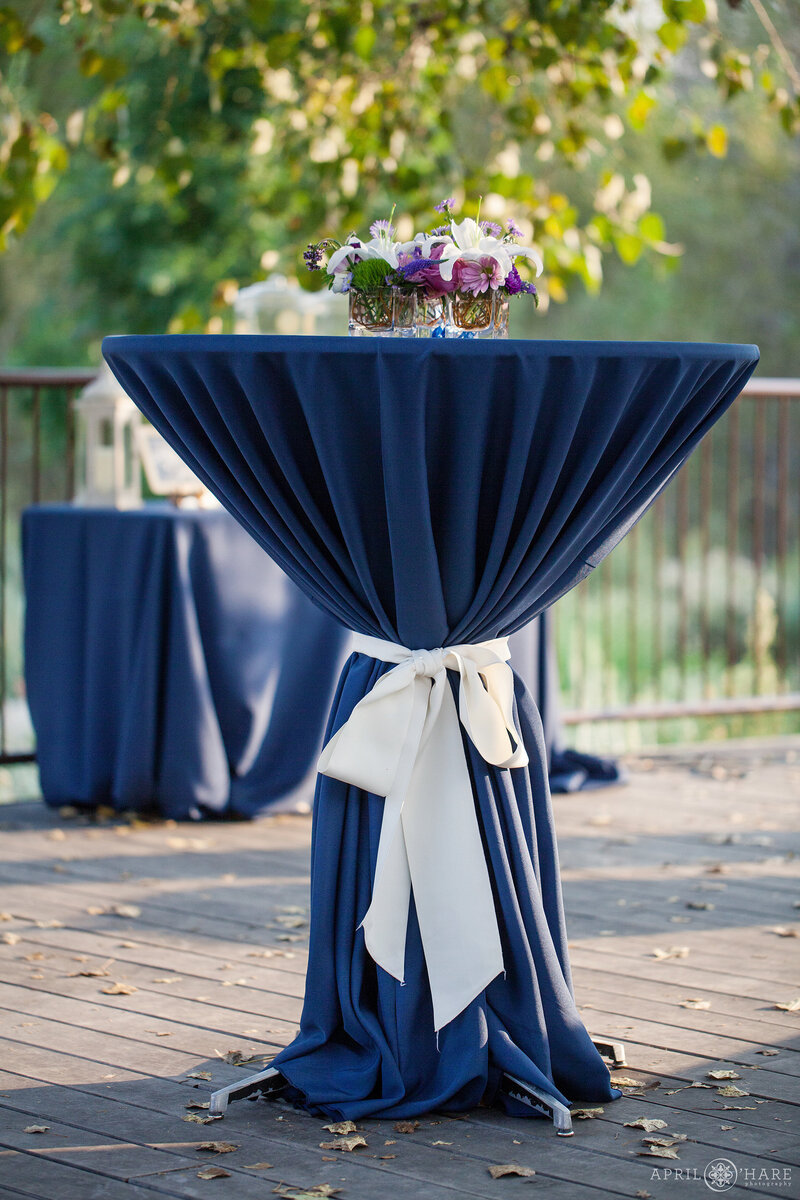 Cocktail tables set up on teh Prairie Garden Terrace at Chatfield Farms