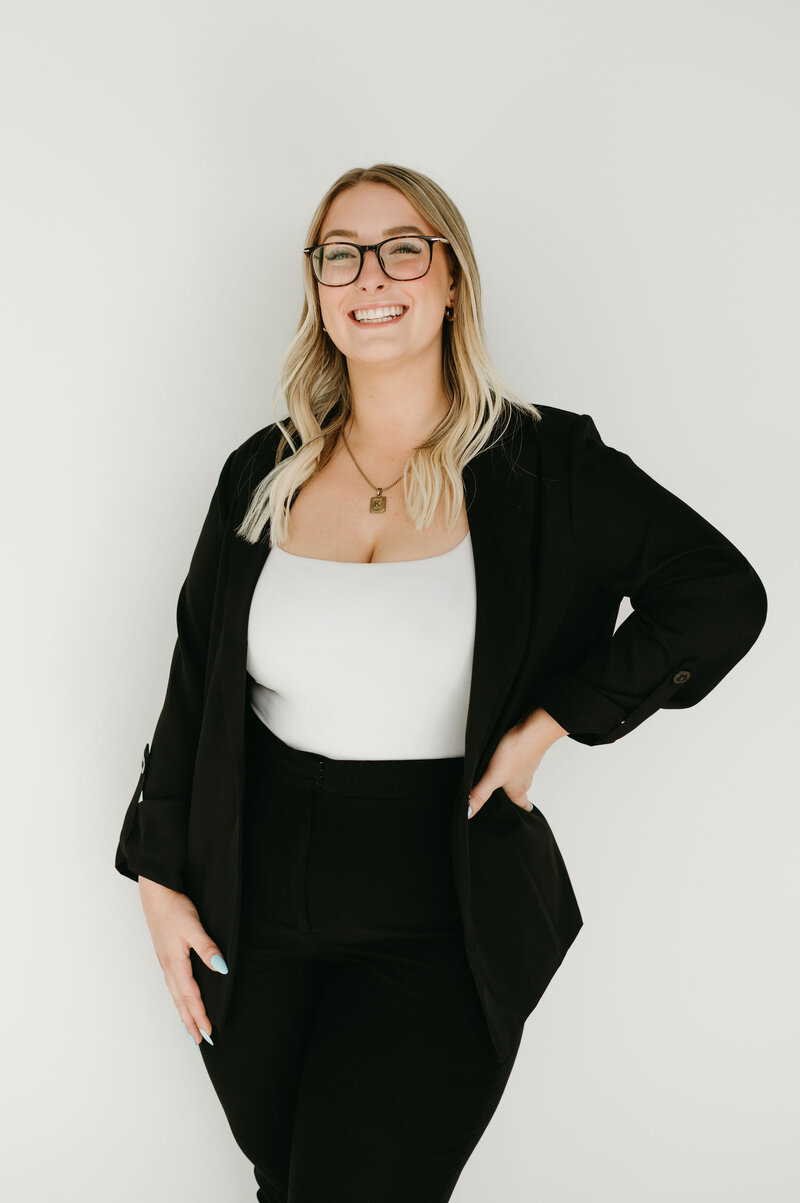 Kayla's headshot standing against white backdrop