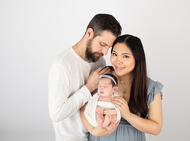 Mom, dad and baby in studio for newborn photos by Baltimore newborn photographer