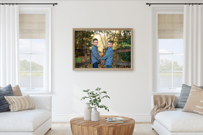 Brightly lit, clean living room with a large picture of two boys on the wall