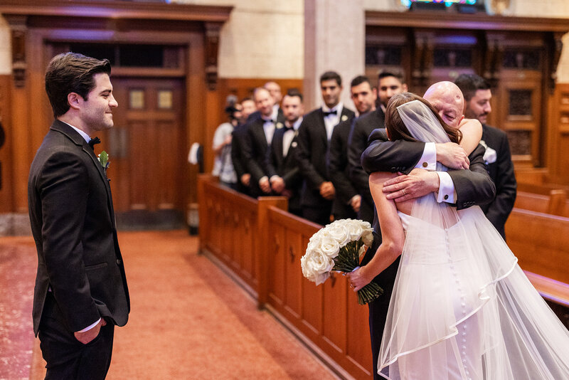 bride touching dad's face during first look at luxury wedding in Chicago