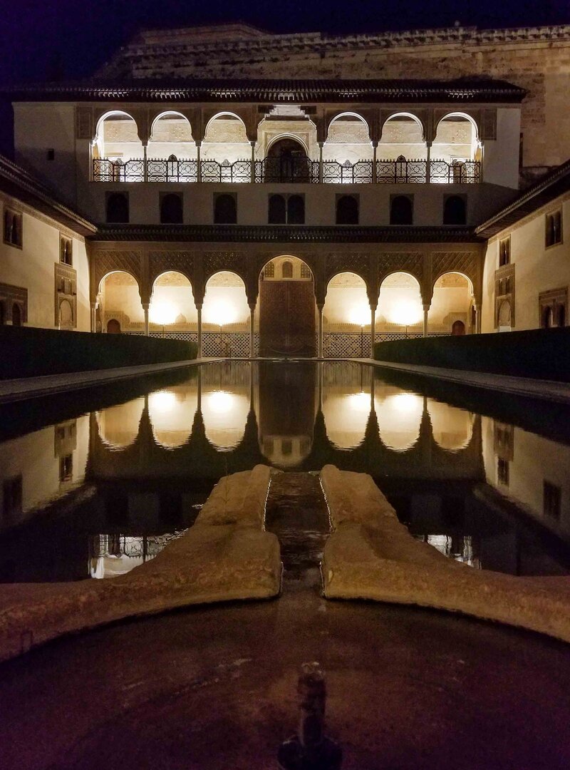 A courtyard reflected in a pool during a nighttime visit to the Alhambra palace in Granada, Spain ©Stephanie Dosch | theViatrix Luxury Travel
