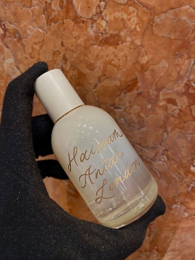 cream bottle with gold calligraphy engraving 