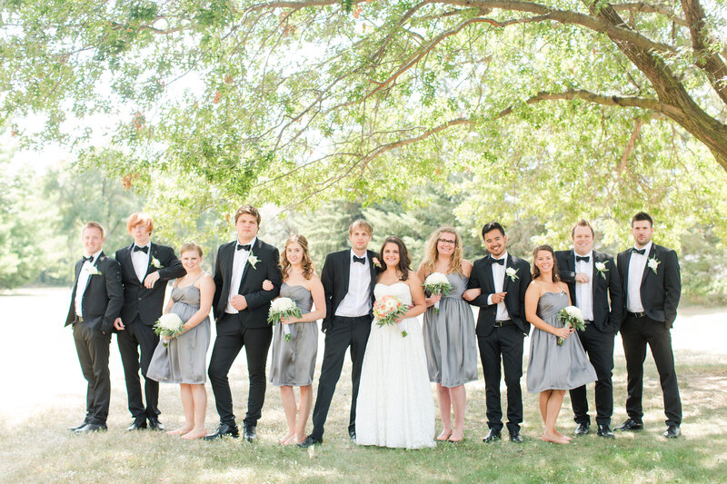 Wedding party posing in front of a huge tree