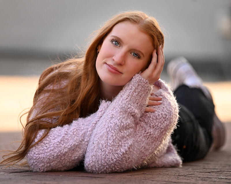 girl with red hair in pink sweater