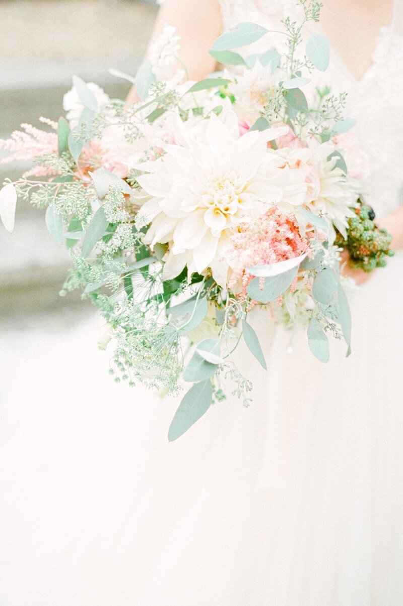 dreamy pastel wedding bouquet with dahlias, eucalyptus, and pink astilbe for an English castle wedding
