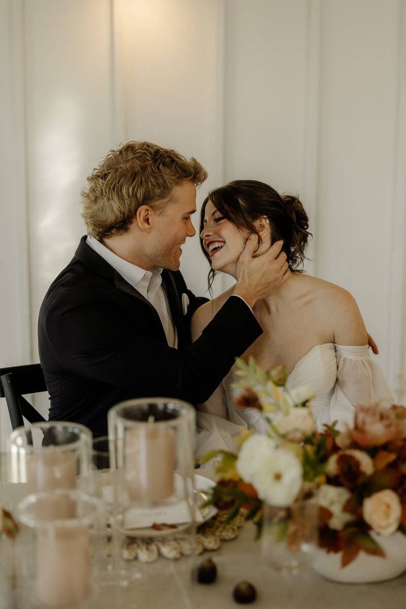Intimate elopement ceremony as the happy bride and groom are captured embracing on the courthouse balcony.