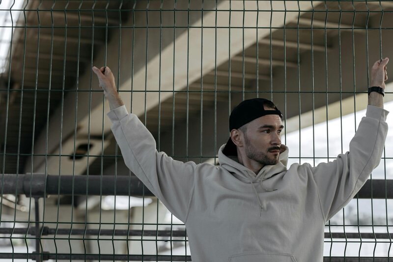 Personal Trainer hanging on fence