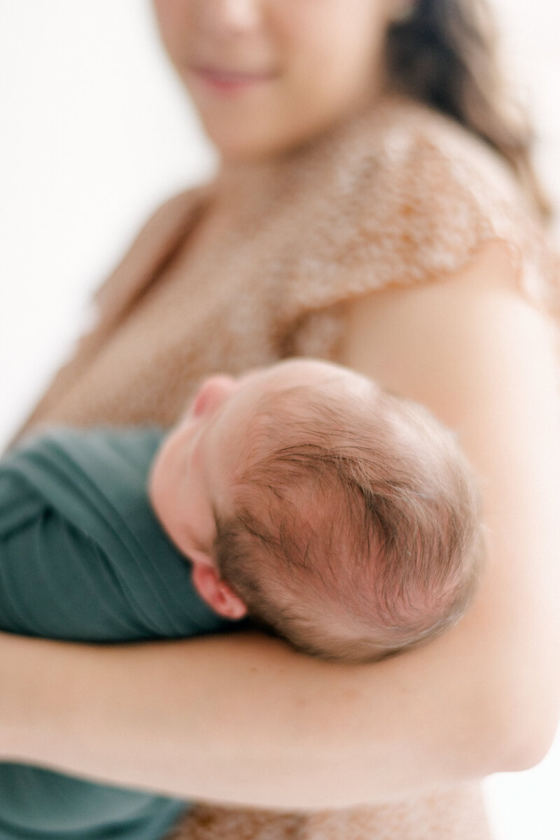newborn photo with top of baby's head in focus