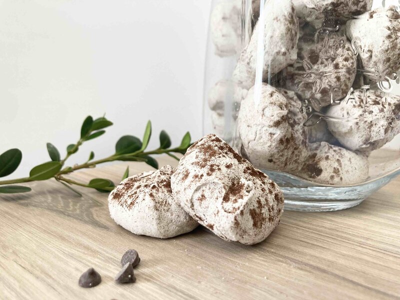brown meringue cookies with chocolate powder and chocolate chips.