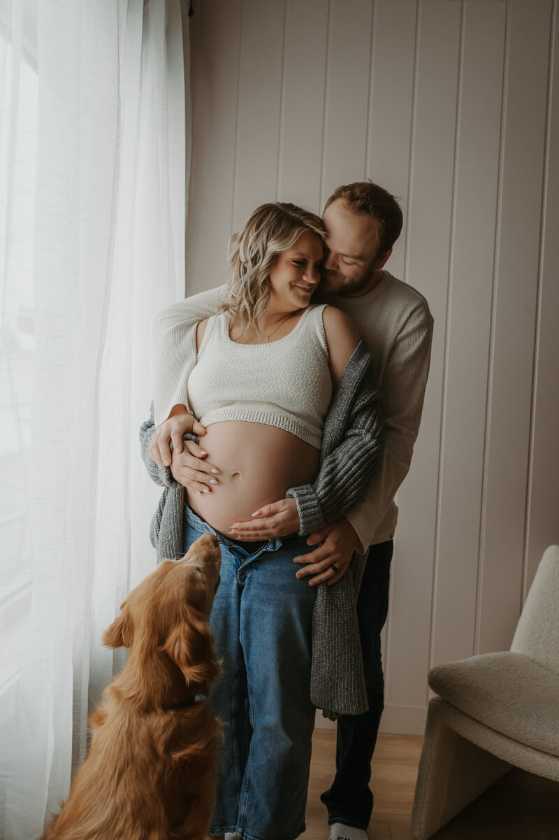 Expecting Couple photographed in Edmonton Photography studio with dog