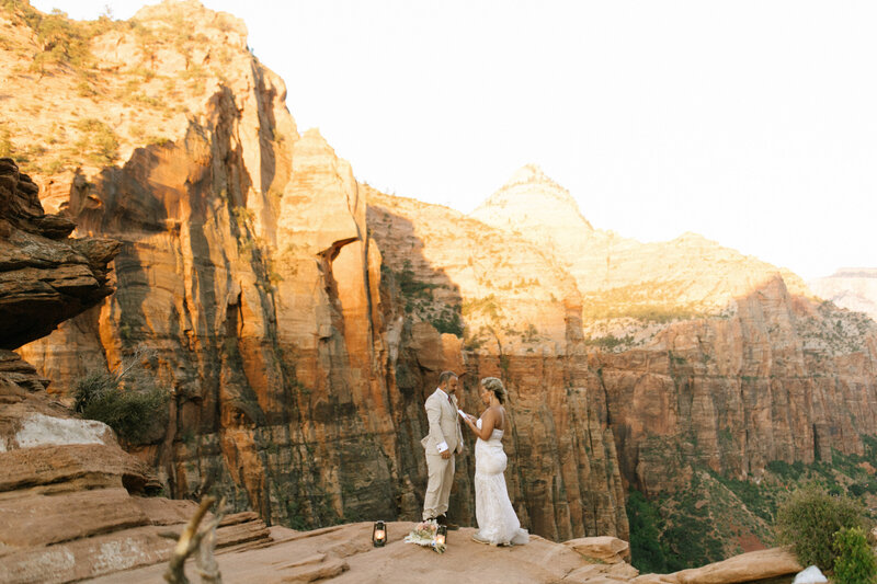 Couple exchanging vows at Zion National Park overlook captured by Utah elopement photographer