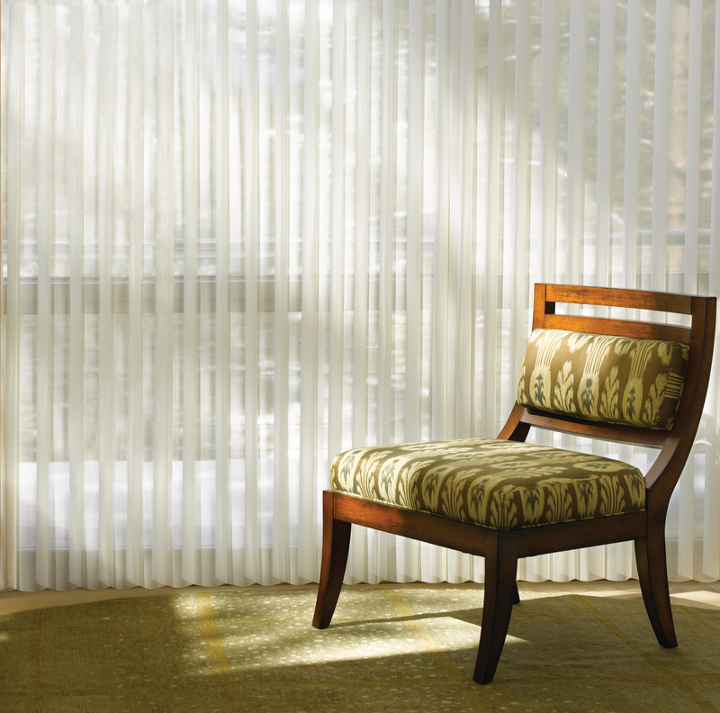 Sheer shades with a patterned chair