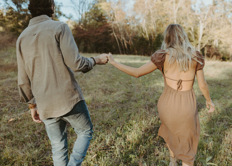 couple holding hands during a fall engagement session