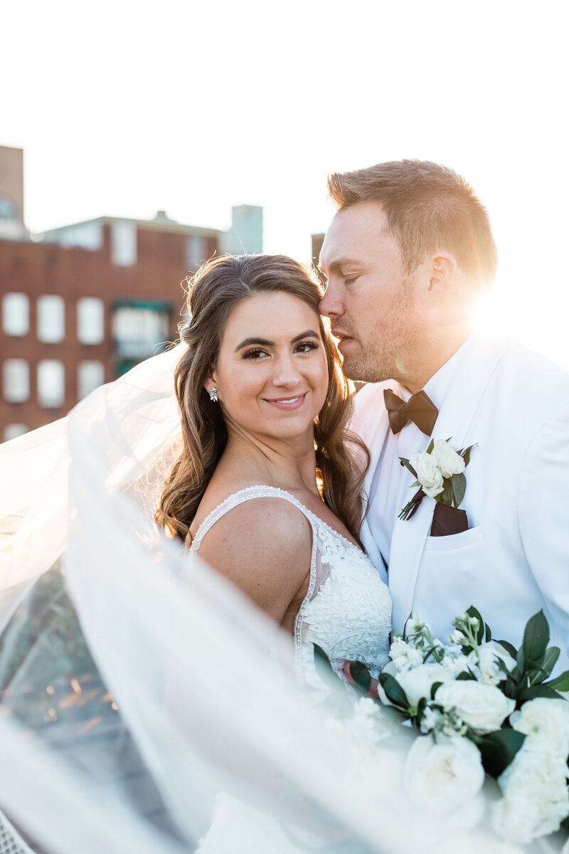Couples takes photos in the ocean on the gulf coast of Florida