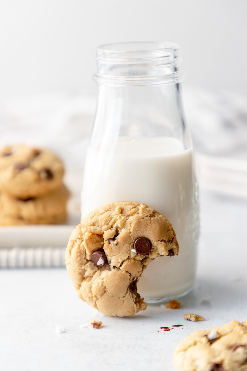 a chocolate chip cookie and a glass of milk