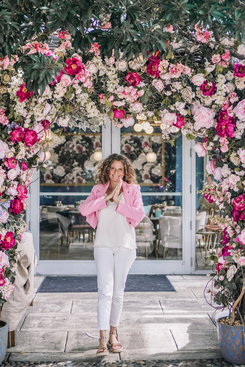 Woman under a flower arch