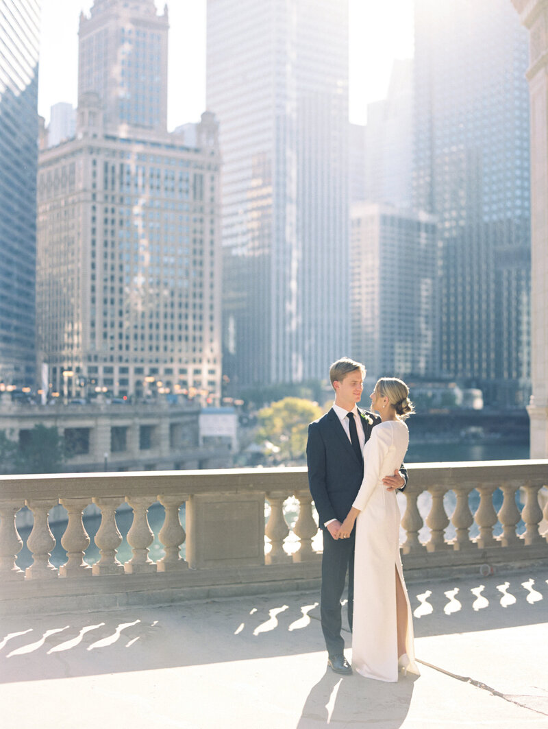 Bride and groom embracing in city photographed by Chicago editorial wedding photographer Arielle Peters