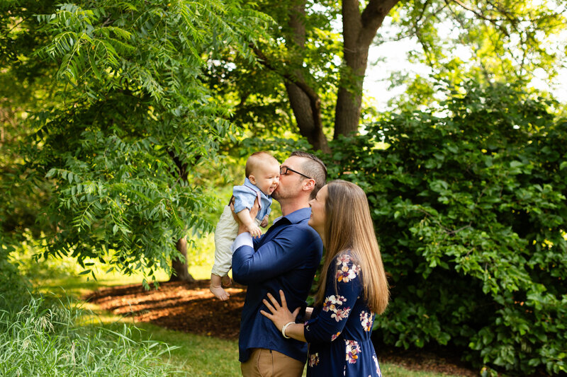 Dad, mom and little boy smiling a the camera at fall family session in Chicagoland area