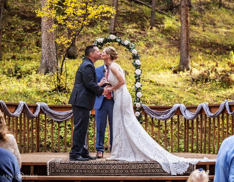 Wedding Ceremony Kiss in the Fall Color Forest at Beaver Ranch in Colorado