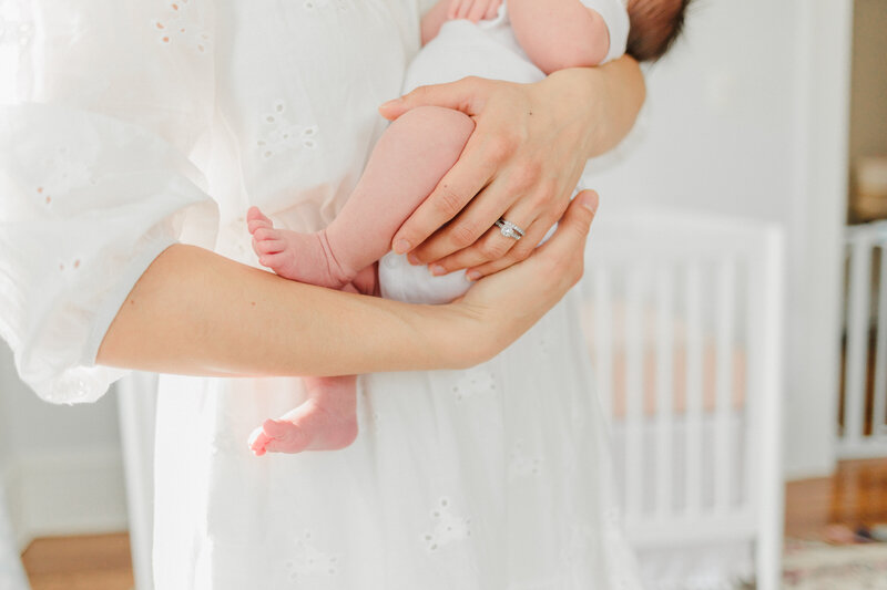 Mama holds newborn baby during In-home Newborn session with Asheville newborn photographer Rachel Marie Photography