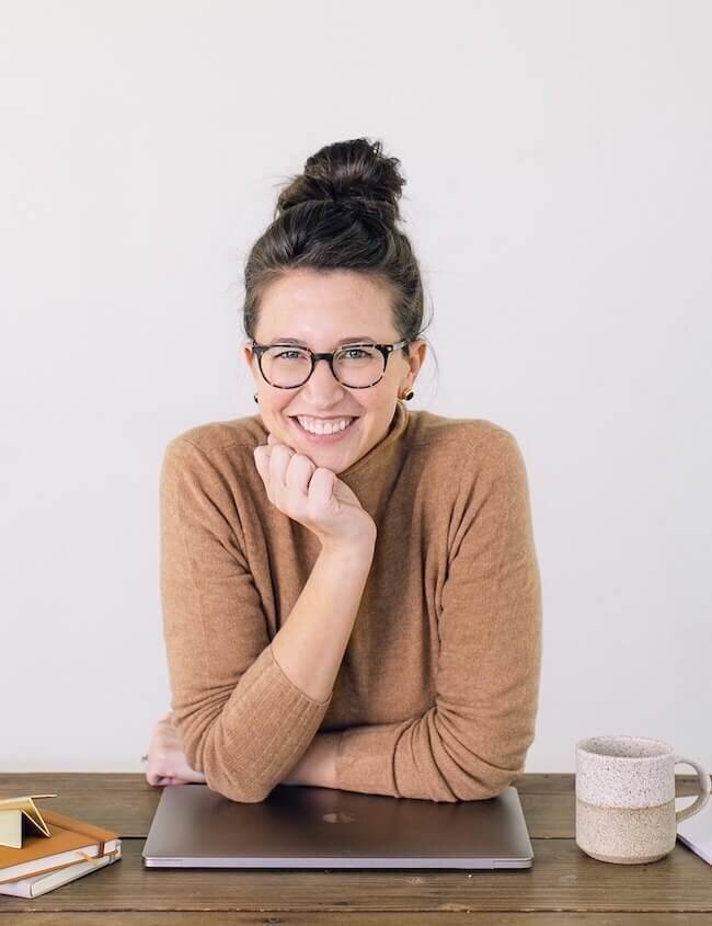 Kelly Nolan with arms resting on laptop – The Bright Method Time Management System