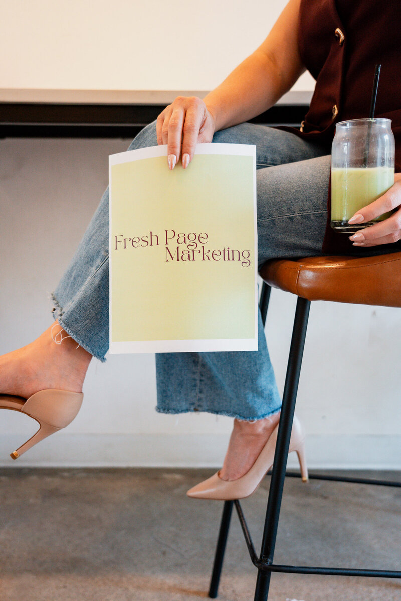 Fresh Page Marketing sign with coffee and casual setting, symbolizing ecommerce management, copywriting, and website design services for small businesses.