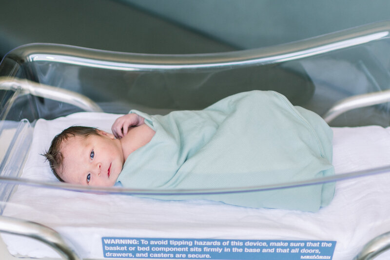 newborn in hospital bassinet