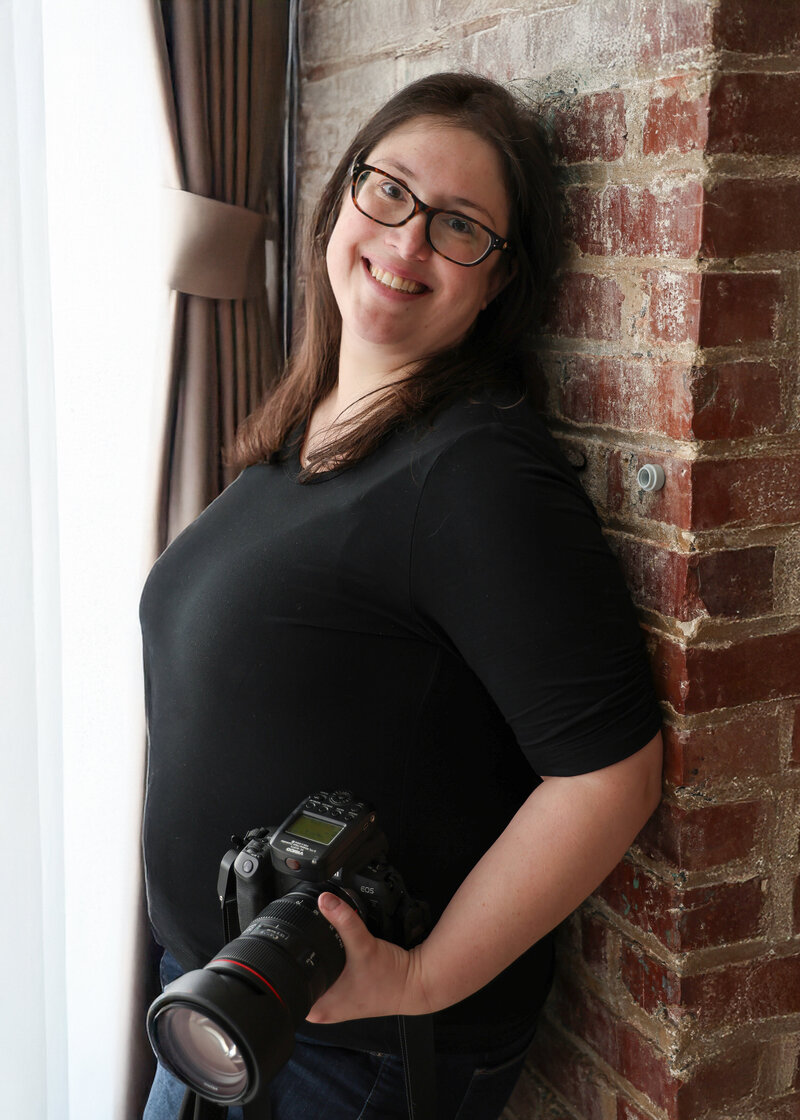 Photo of Allison Reilly holding her camera