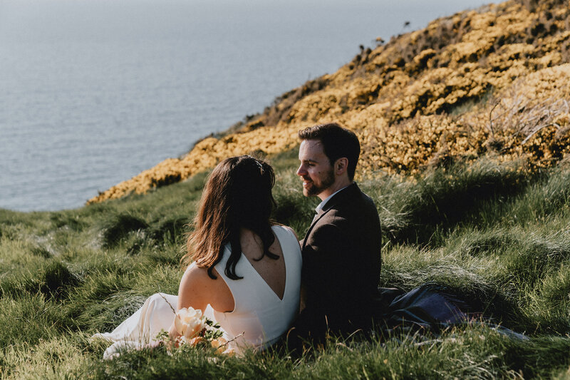Engaged couples kissing on the beach in Pembrokeshire