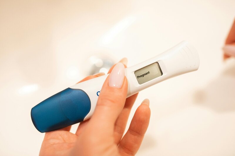 Woman holding pregnancy test in her hand