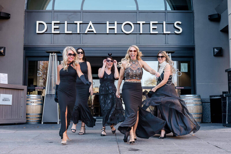Group of Powershouse women walking through the doors of the Delta Grand hotel downtown Kelowna.