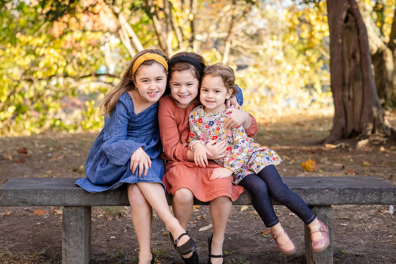 Siblings hugging at an Essex County, NJ park in the fall.