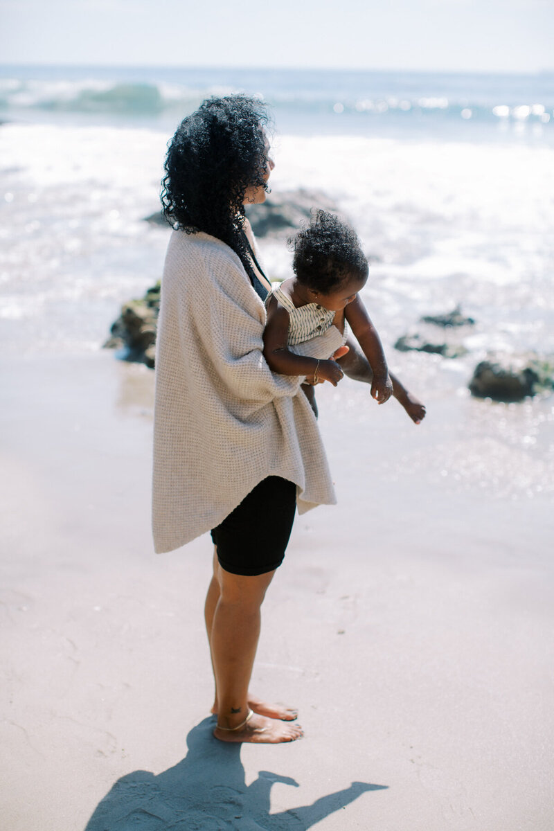an image of a black mother and daughter on a website for online coaching for moms of color in Matrescence.