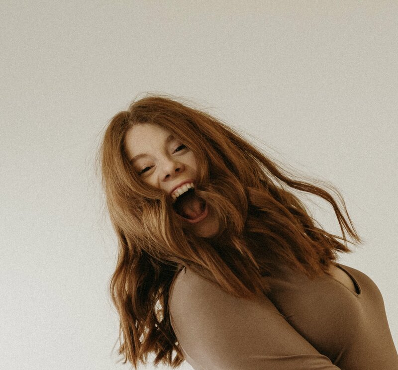 Portrait of ZoeyLynn, owner and lead photographer, showcasing her professional expertise in capturing timeless moments and beautiful photography.