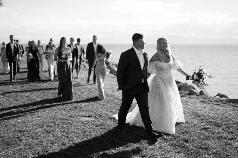Bride and Groom kiss on stair filled with lush florals in Charleston.