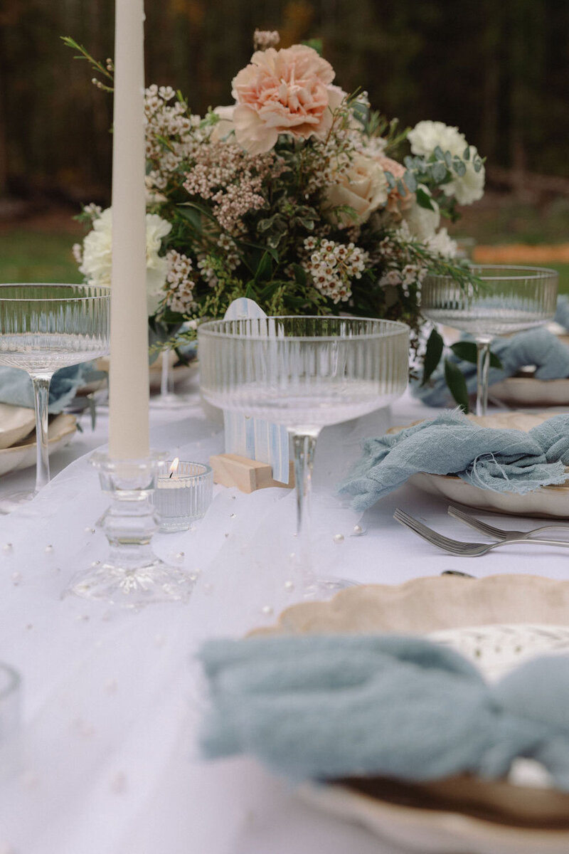 Elegant tablescape with blue linens and floral centerpiece