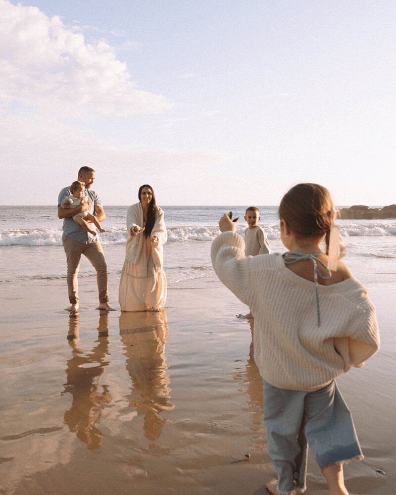 Candid family photo session at Shaw’s Cove in Laguna Beach during sunset by Orange County family photographer.