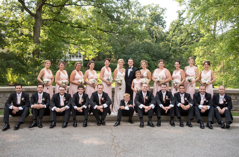 Bride and groom pose for portraits with their wedding party