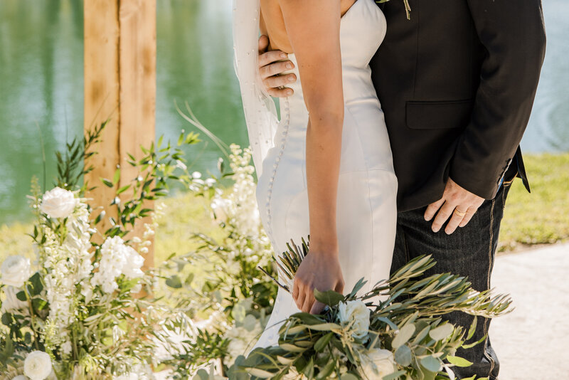 The bride and groom standing face to face.