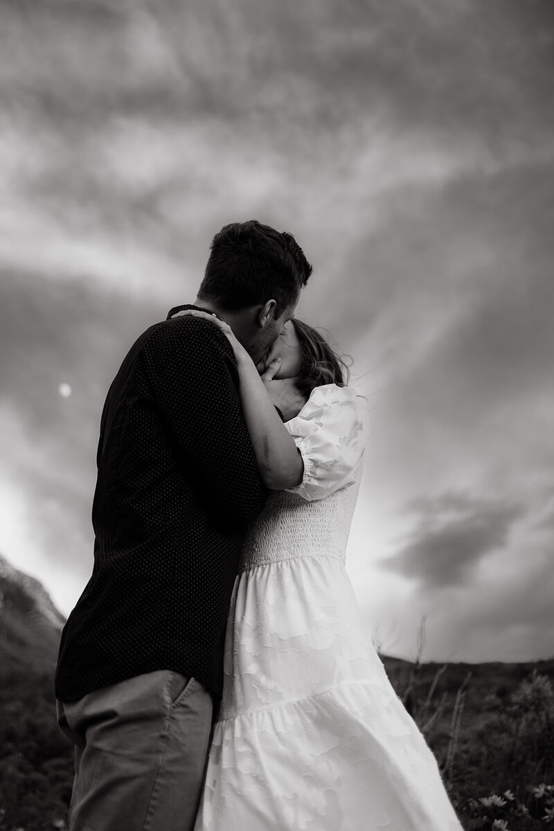 couple kissing each other during engagement photos
