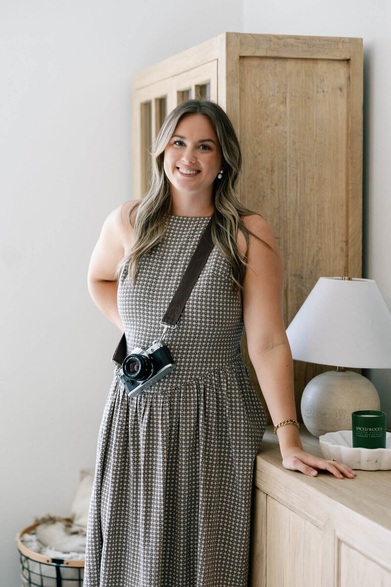 south florida wedding photographer smiling with camera around neck