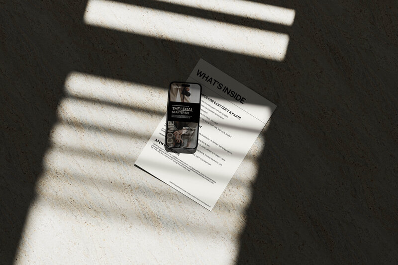 Overhead view of printed photography contract templates and mobile preview of the Legal Starter Kit for photographers