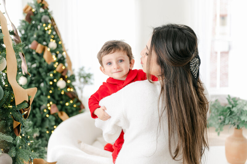 Boys in Christmas Pajamas with Santa sneaking in behind them