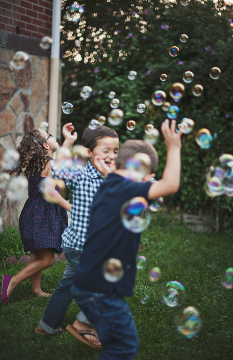 kids-playing-in-yard-after-roxi-and-co-cleaned-up-dog-poop-in-backyard